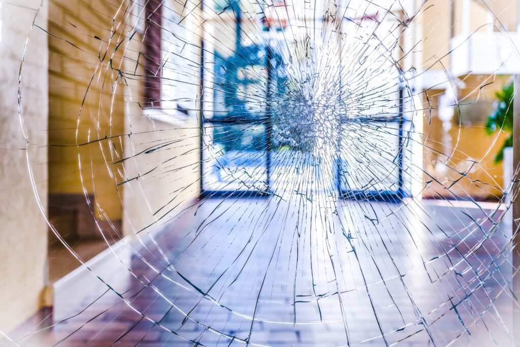 A window that has shattered but held in place because of security window film installed